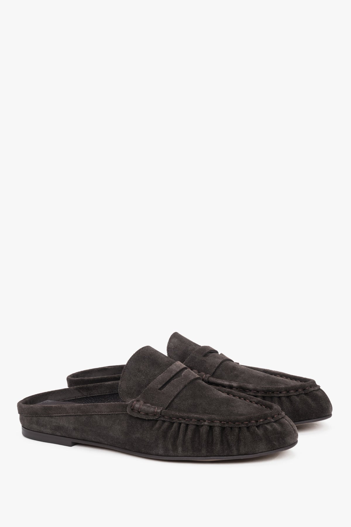 Dark brown suede Estro mules, showcasing an elegant backless silhouette and meticulously crafted stitching on the upper for a refined, sophisticated look.
