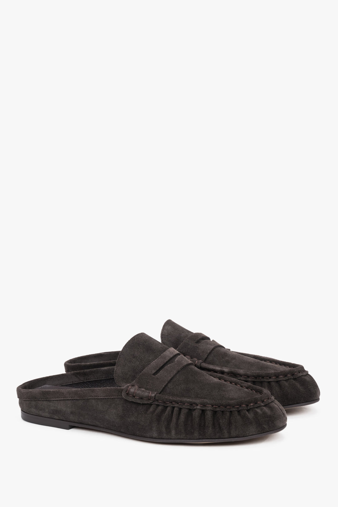 Dark brown suede Estro mules, showcasing an elegant backless silhouette and meticulously crafted stitching on the upper for a refined, sophisticated look.