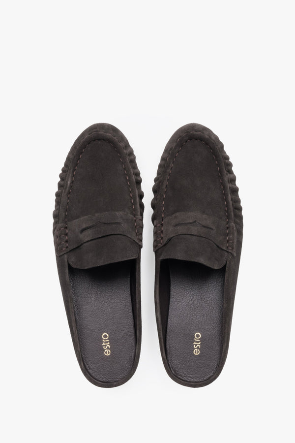 A pair of mules displayed to highlight the loafer-style closed front with a decorative cross strap and a sleek, dark-colored insole.