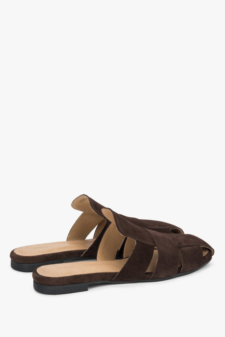Rear view of the mules, showcasing an open heel and the finely crafted edges of the luxurious natural suede upper.