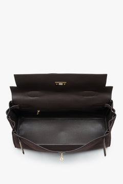 Made of genuine velour — a dark brown women’s shoulder bag with gold hardware from Estro.