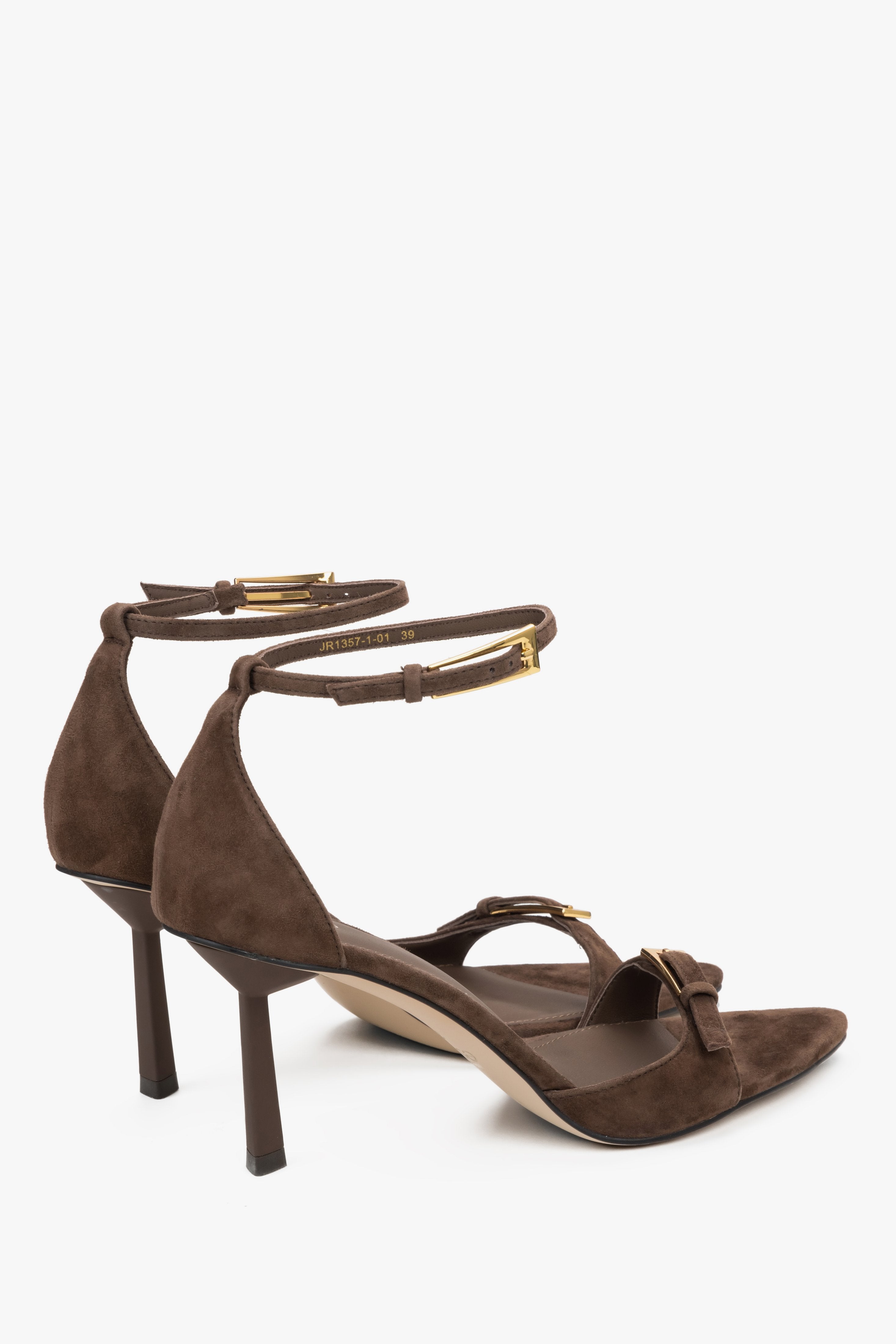 Detail view of decorative buckles on dark brown velour sandal straps.