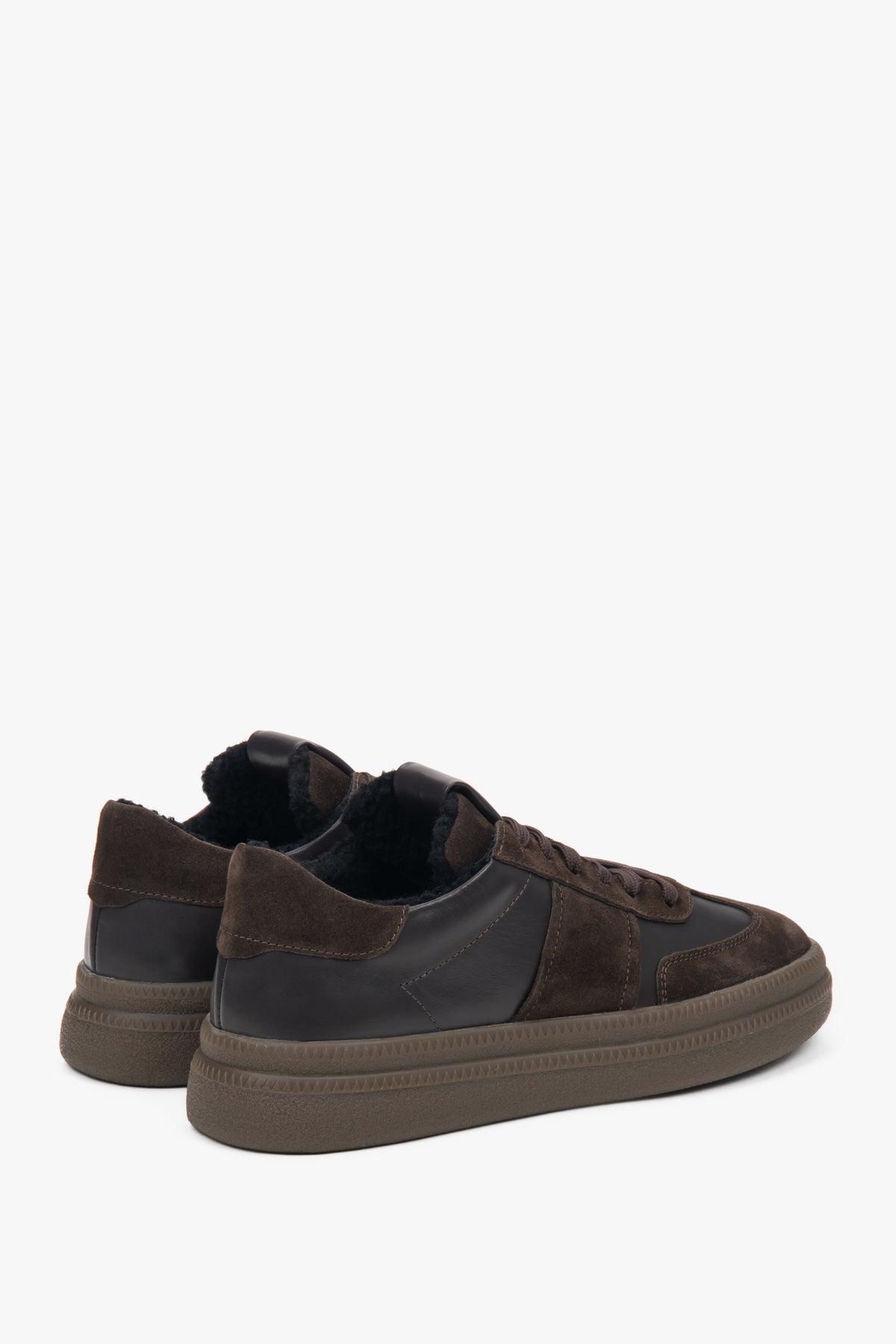Close-up of warm fur lining inside dark brown sneakers.