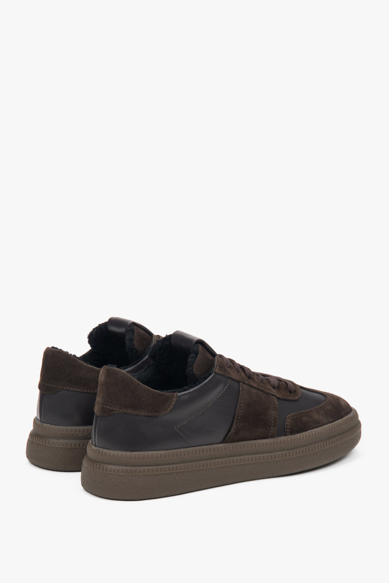Close-up of warm fur lining inside dark brown sneakers.