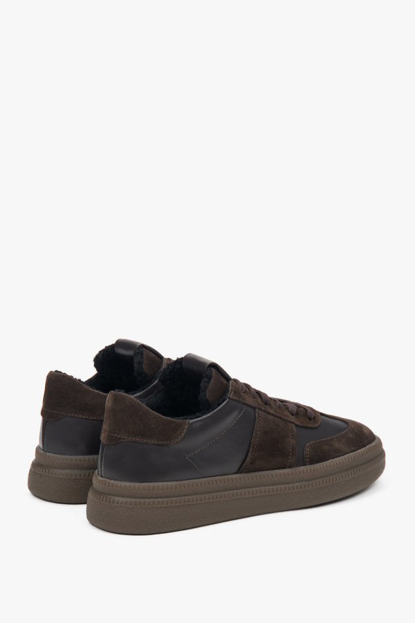 Close-up of warm fur lining inside dark brown sneakers.
