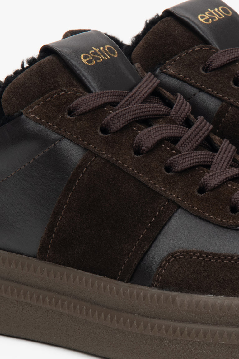 Close-up of dark brown outer material and fur trim.