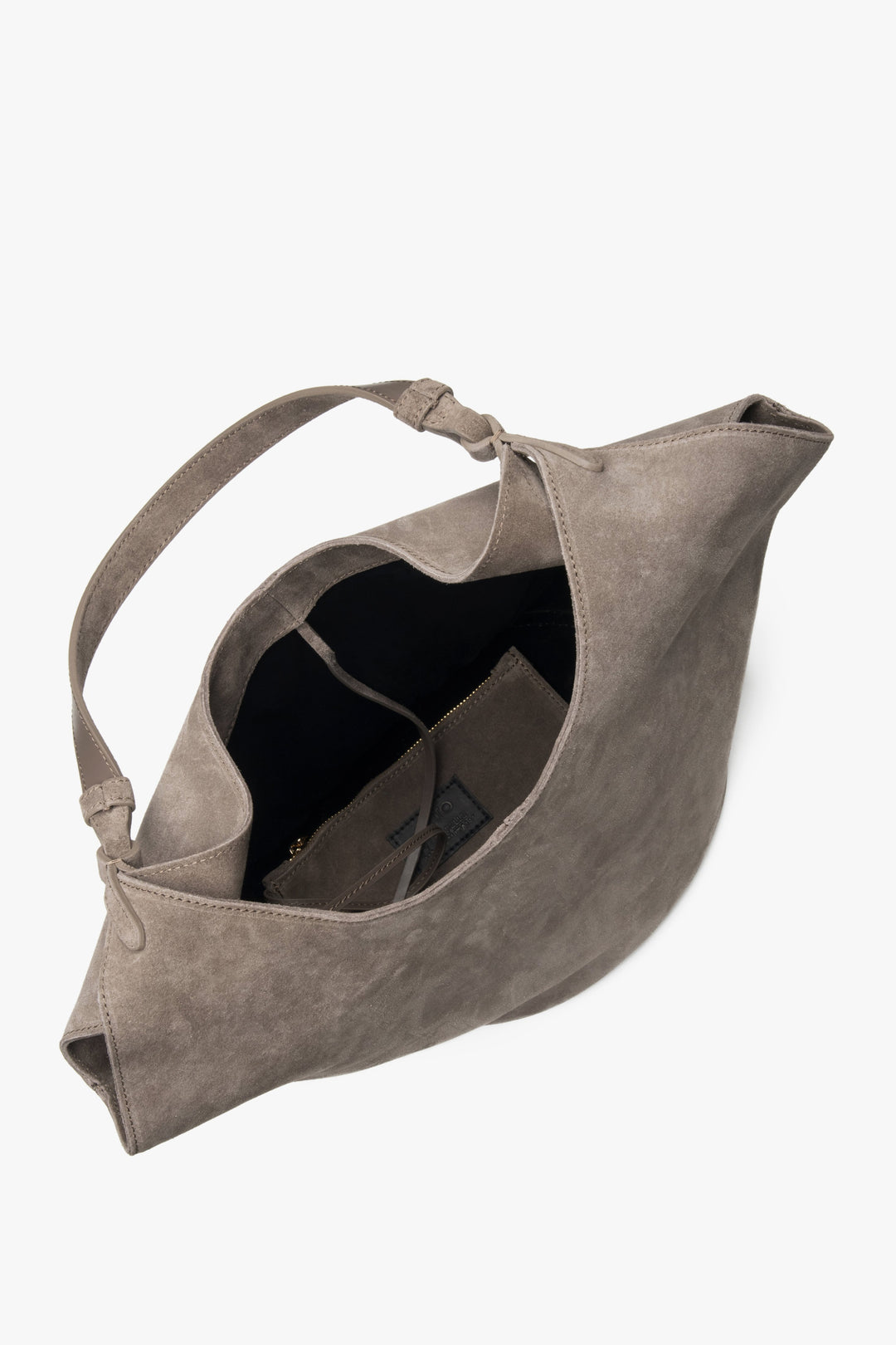 The bag opens to reveal two roomy compartments and two interior pockets, ideal for organizing essentials with ease.