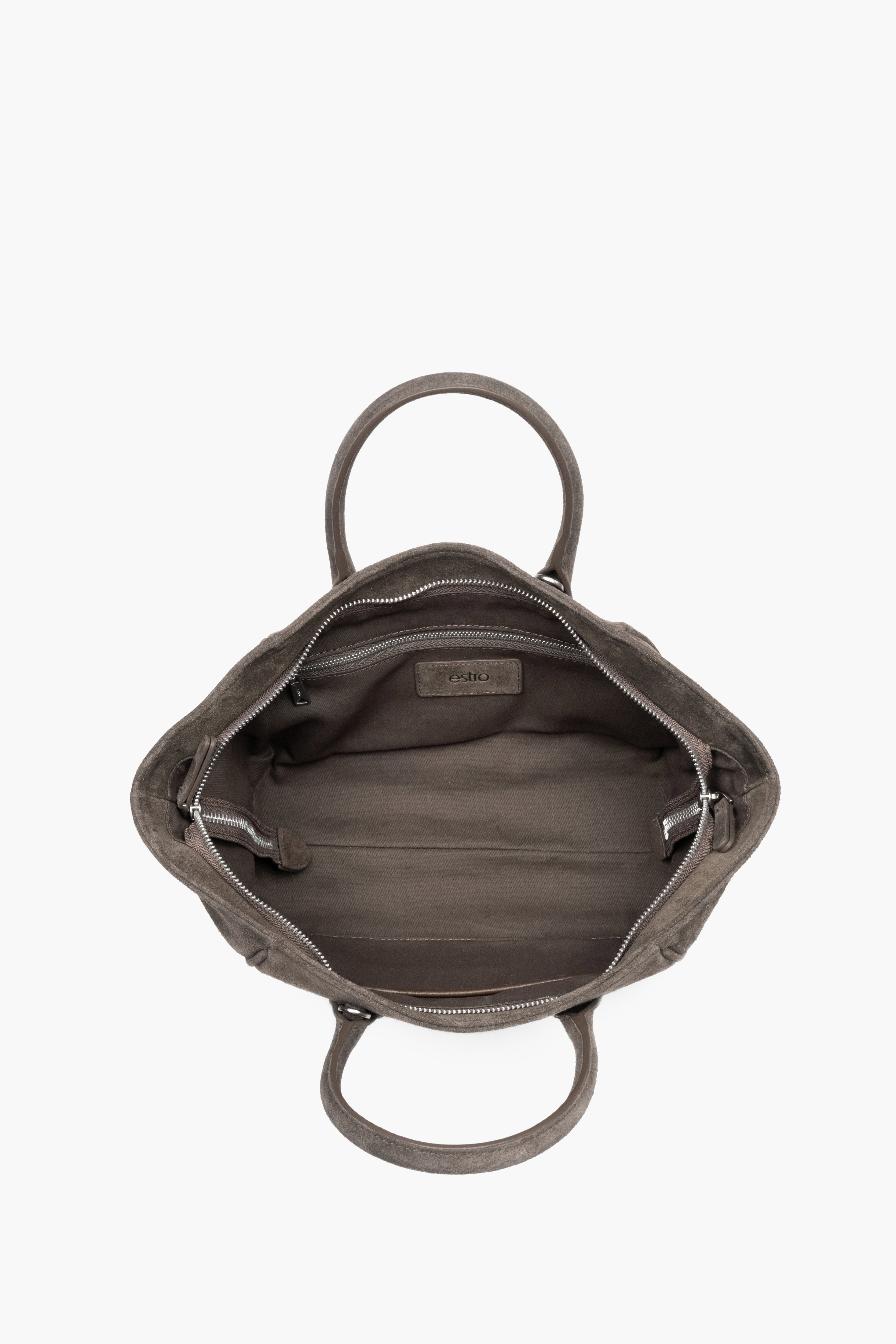 Top view of the open zippered main compartment, showing wide access to the lining and functional internal pockets - dark grey colour.