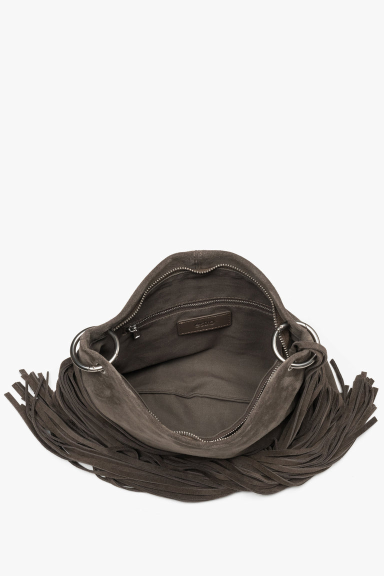 A top-down shot showing the spacious interior with a textile lining, three separate compartments, and smaller pockets.