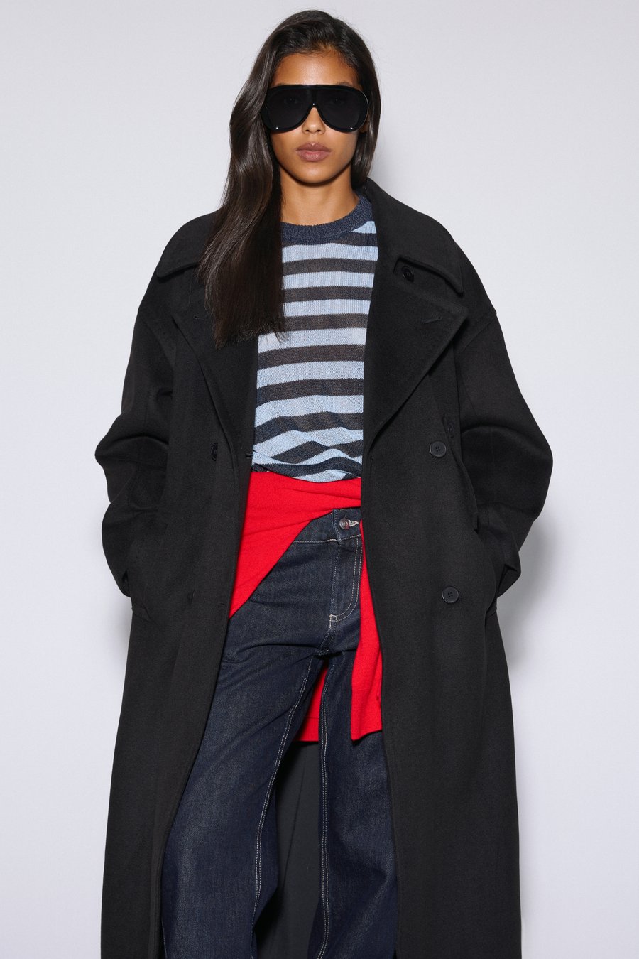 Long women's black natural wool coat, double-breasted design with a belt by Estro.