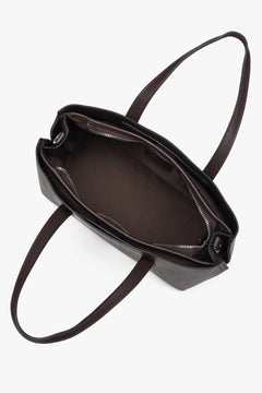 Elegant dark brown tote with dual handles and adjustable shoulder strap, fits A4.