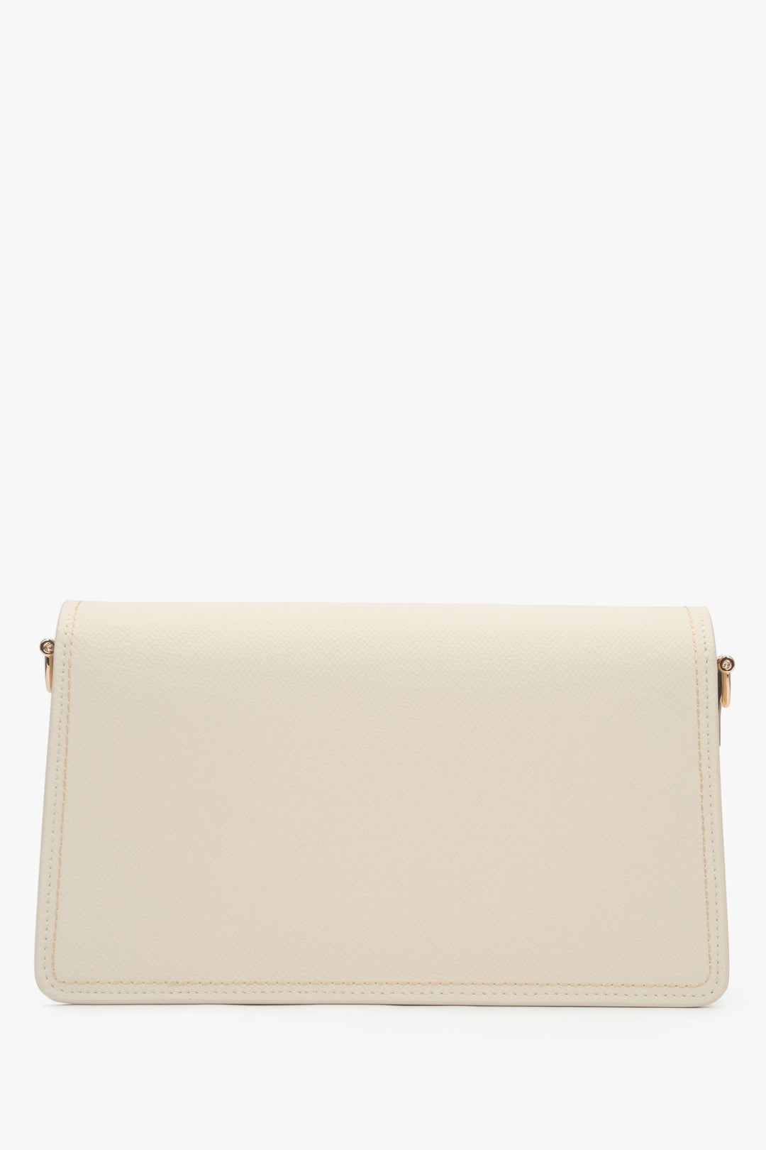 Close-up of the gold-tone snap closure on a milky beige natural leather bag.