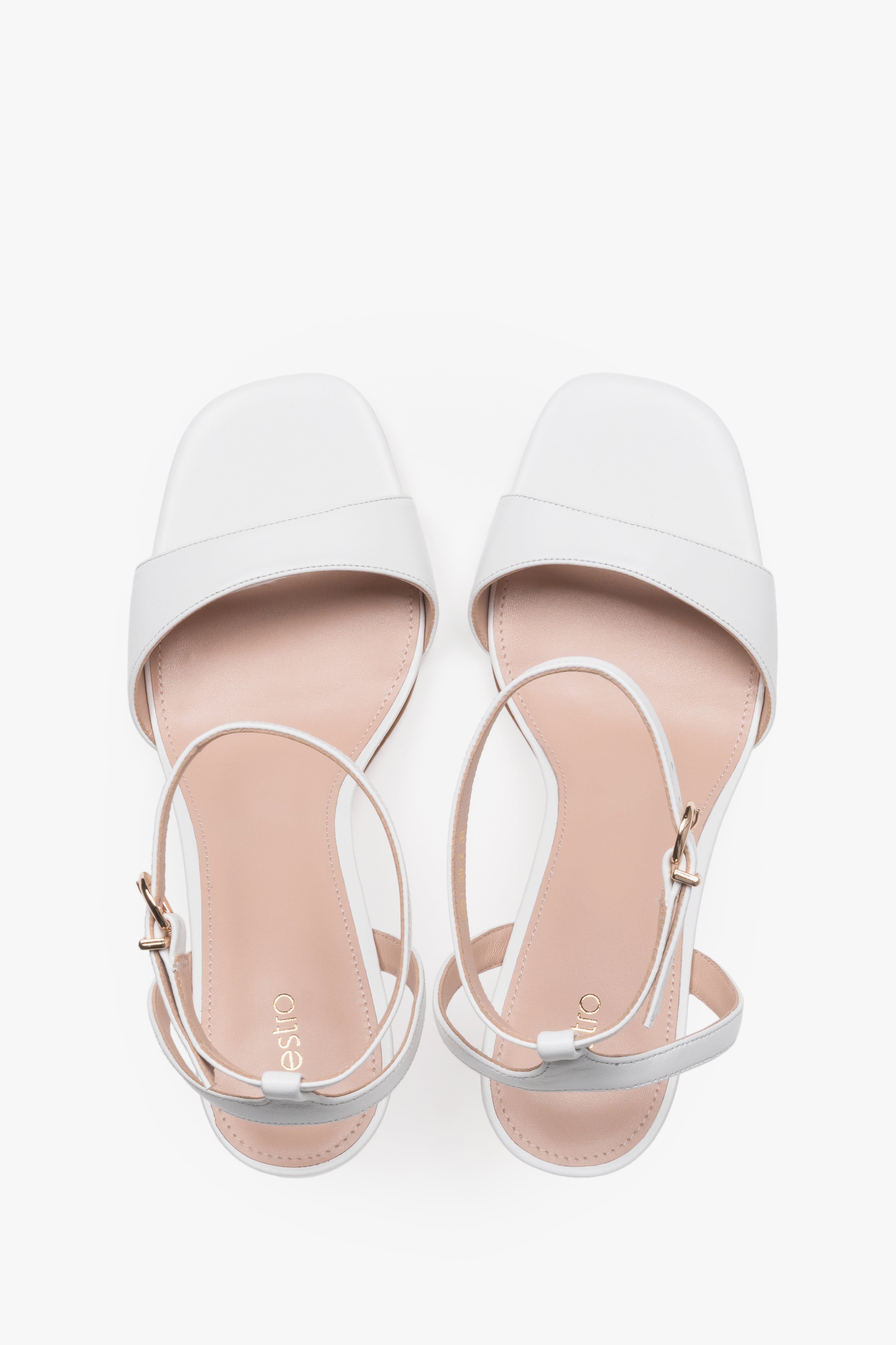 Elegant white leather high-heel sandals with chevro lining.