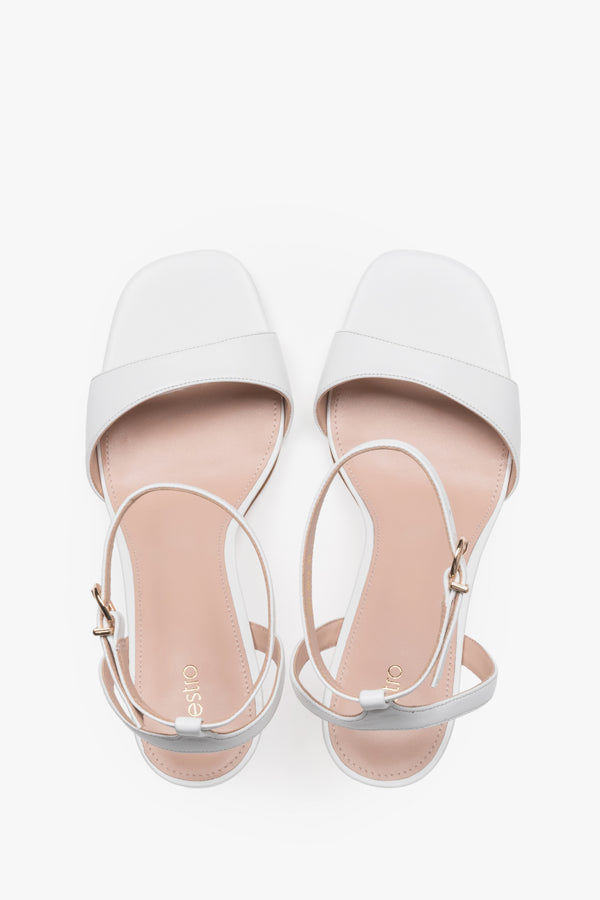 Elegant white leather high-heel sandals with chevro lining.