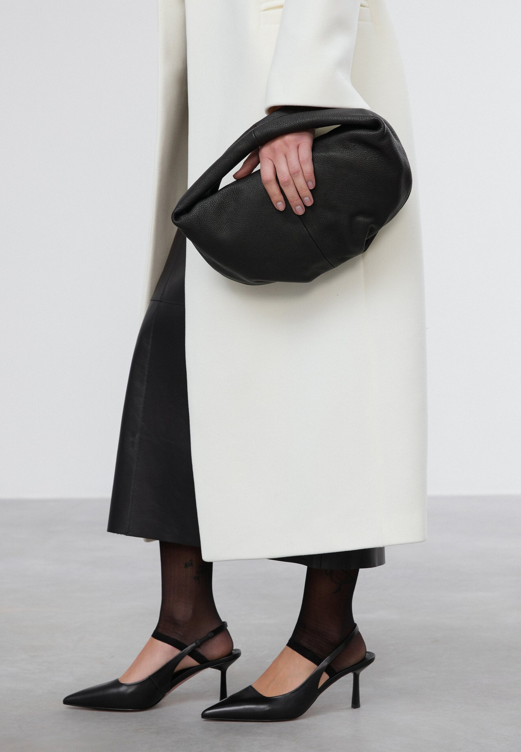 Women's flexible black half-moon bag made of genuine leather.