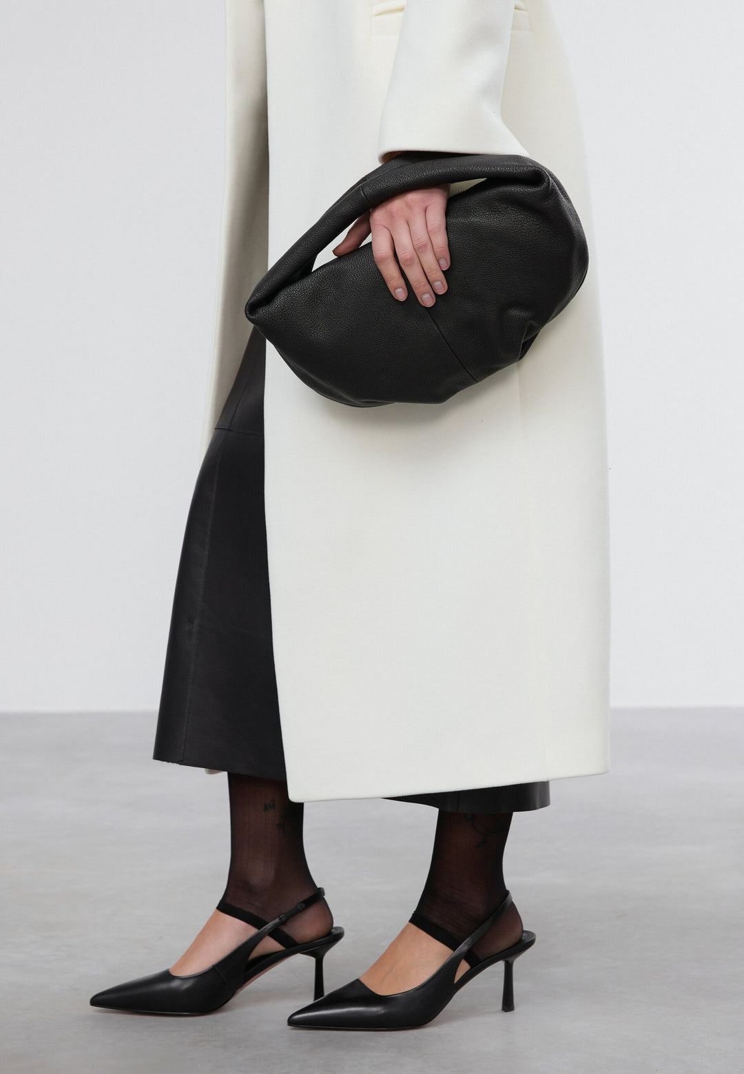 Women's flexible black half-moon bag made of genuine leather.
