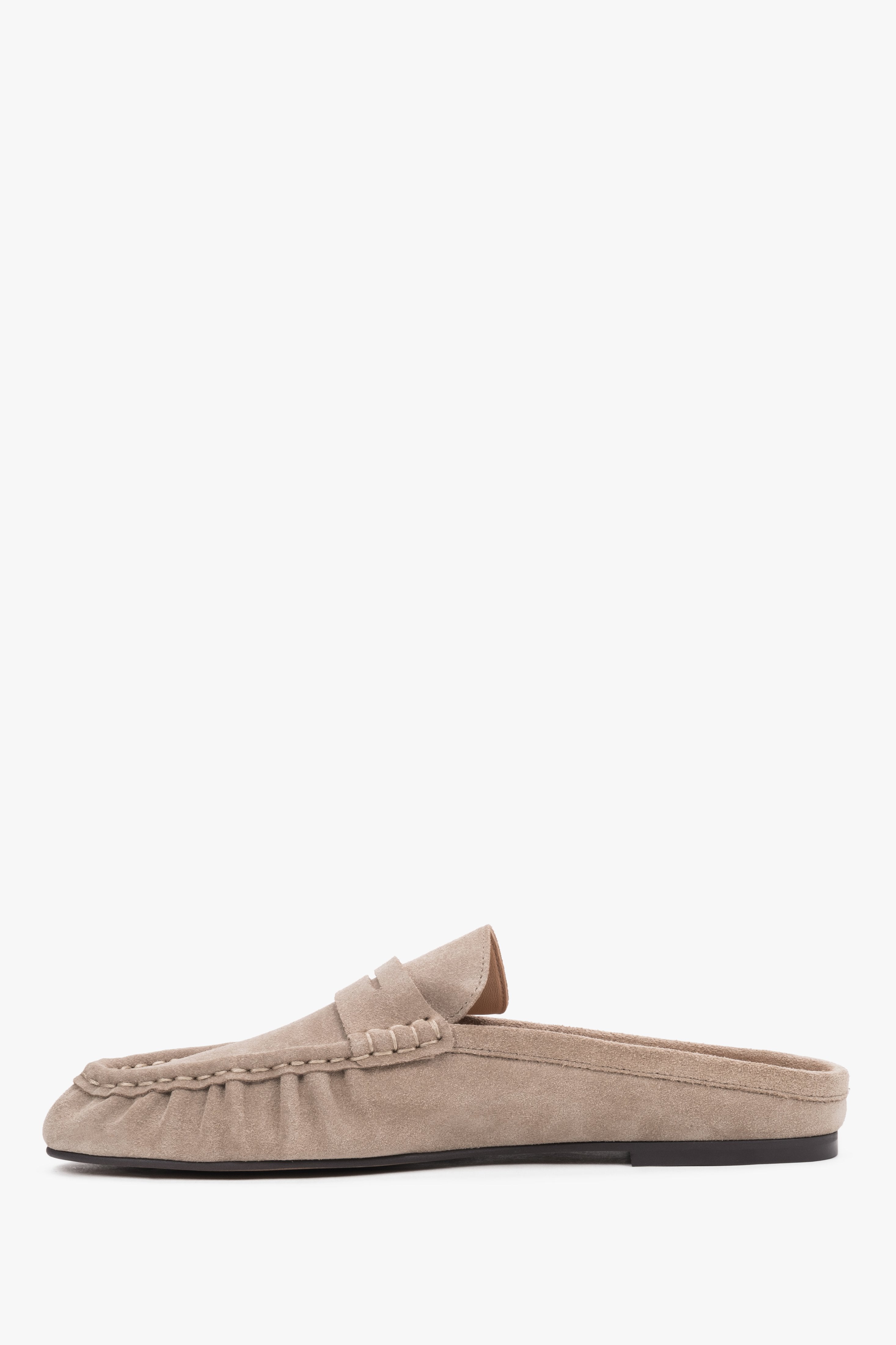 Women’s velour mules showcasing a low, stable sole and a neatly contoured instep design.