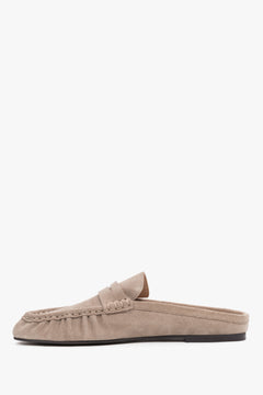 Women’s velour mules showcasing a low, stable sole and a neatly contoured instep design.