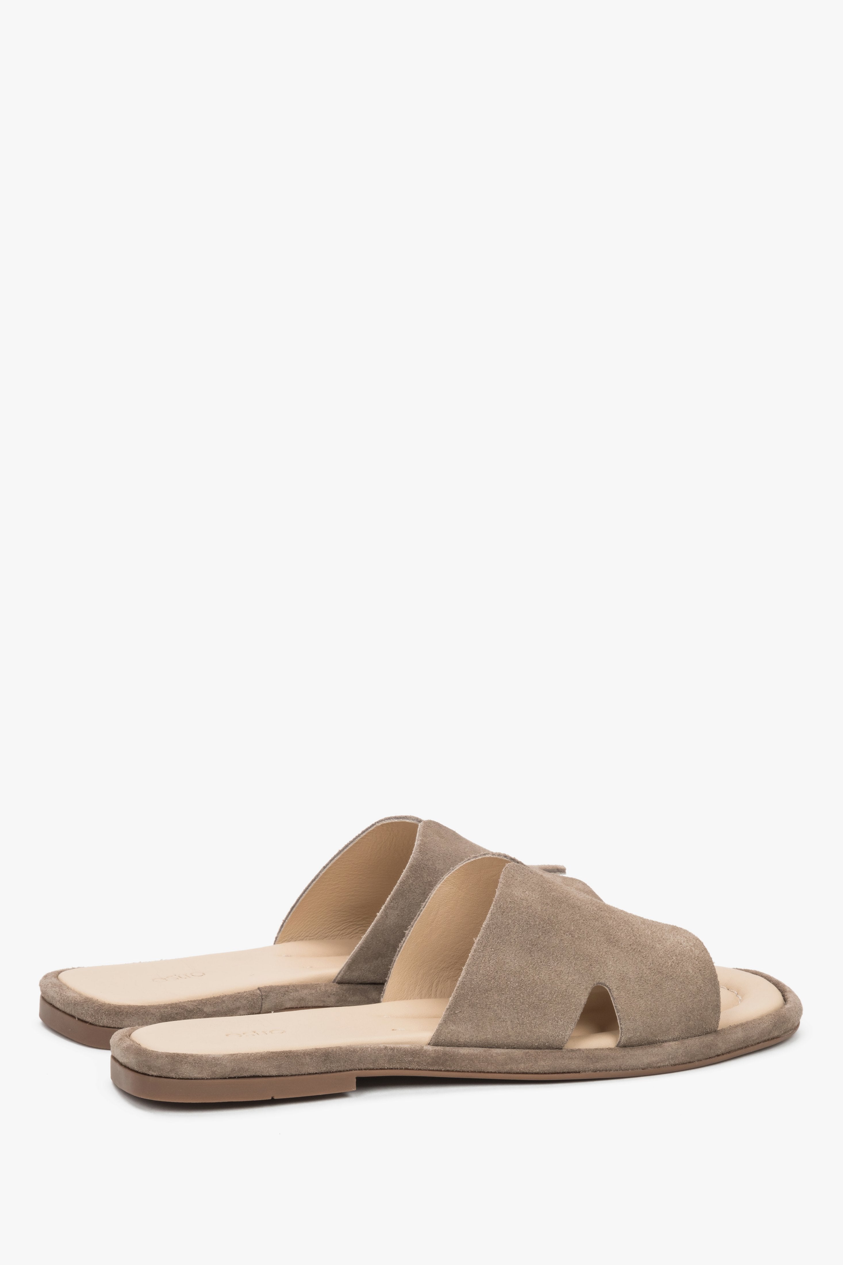 Rear view of the mules showcasing an open-heel construction and precisely finished edges of luxurious taupe velour.