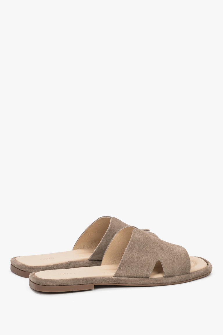 Rear view of the mules showcasing an open-heel construction and precisely finished edges of luxurious taupe velour.
