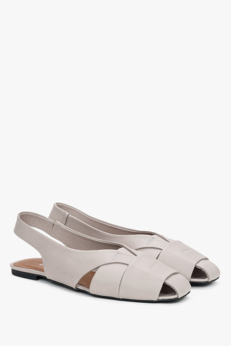 Grey leather women's sandals with closed toe and flat sole.