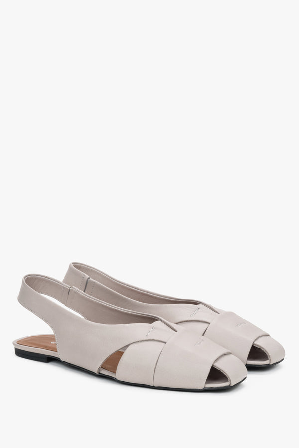 Grey leather women's sandals with closed toe and flat sole.