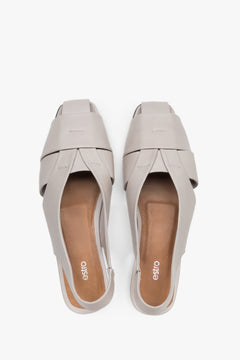 View from above of grey leather sandals with covered toes.