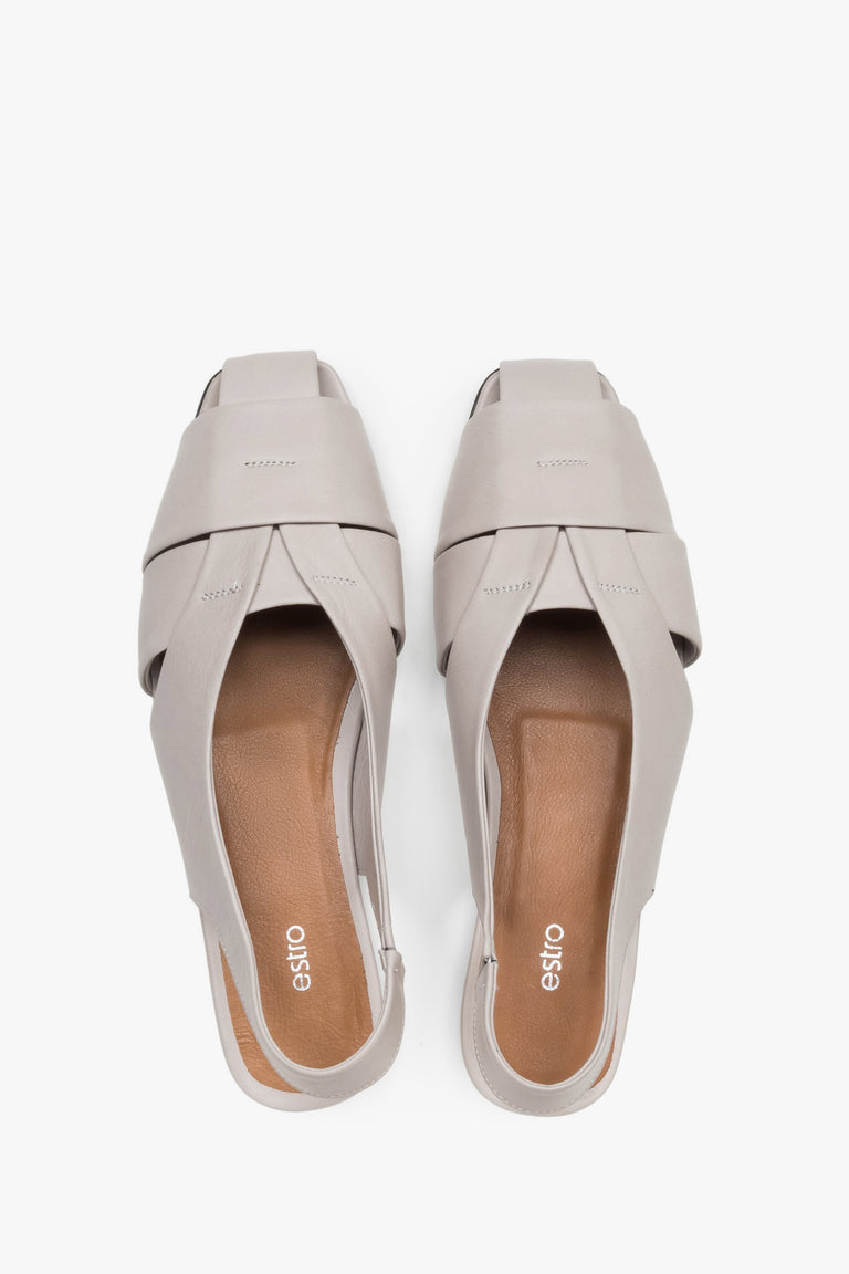 View from above of grey leather sandals with covered toes.