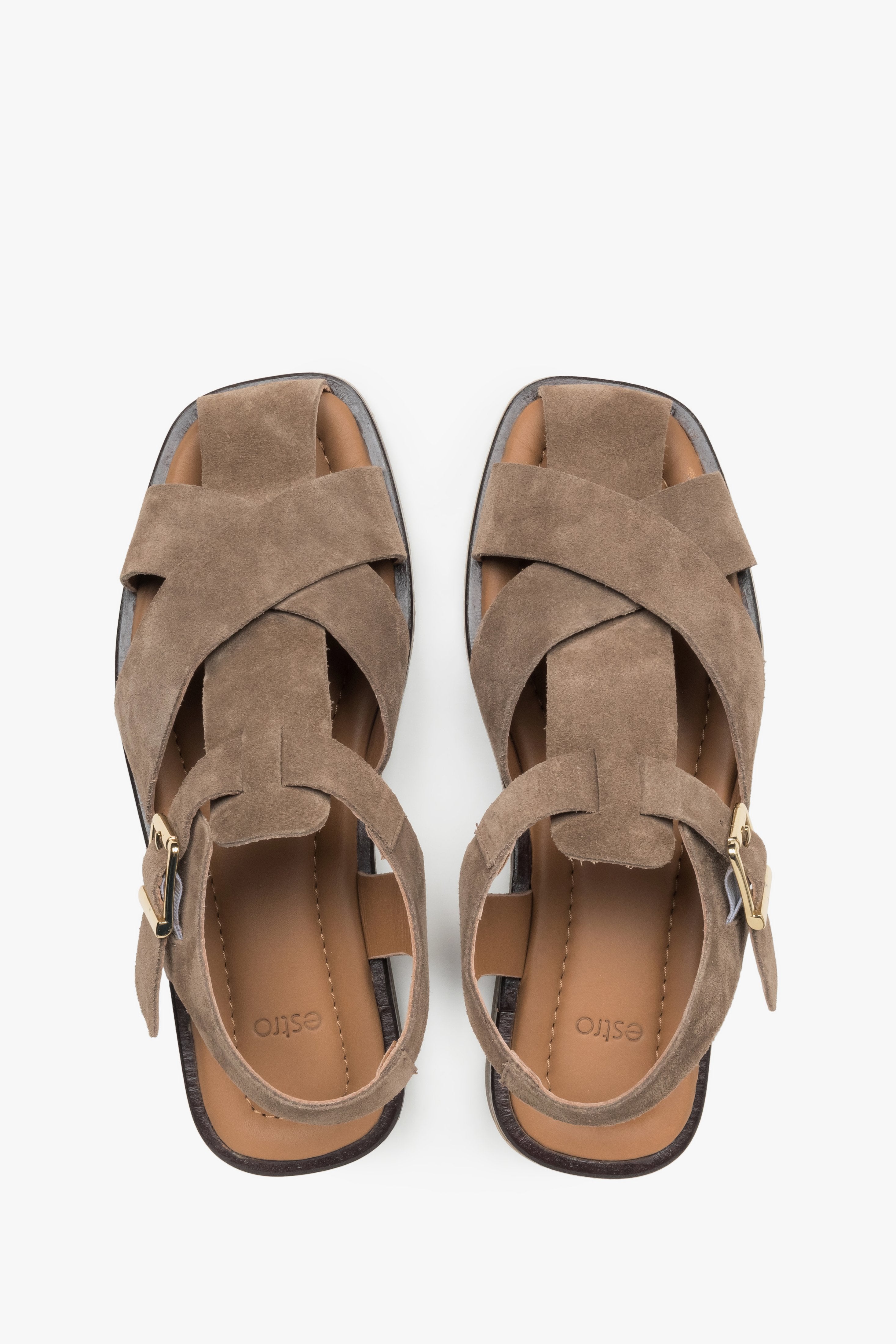 Women’s grey Estro sandals made of natural suede with crisscross straps and a buckle.