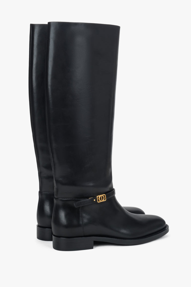 Made of genuine leather, high black women's boots with a gold buckle Estro.