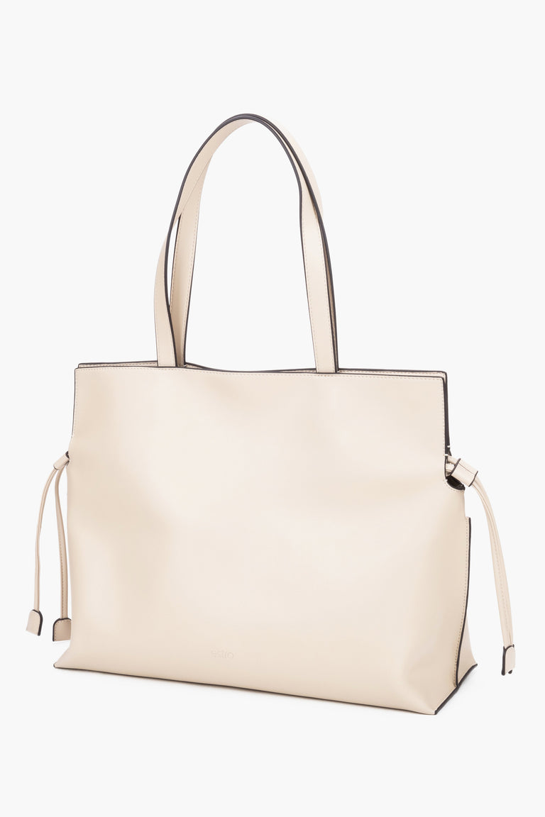 Leather shopper bag with a 14 cm width and loose side ties, showcasing the softness and refined texture of smooth genuine leather - milky-beige colour.