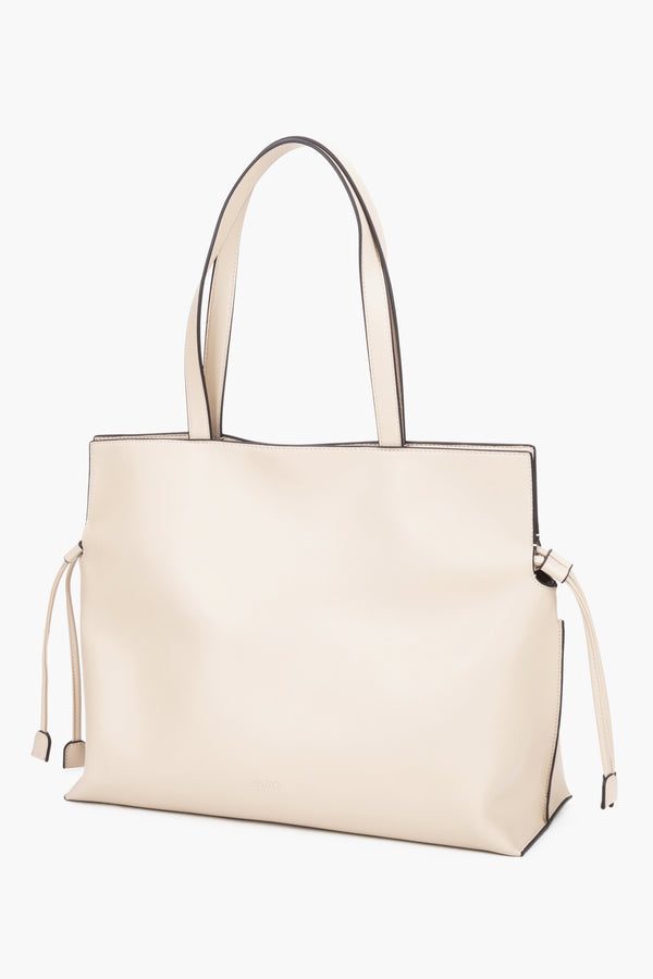 Leather shopper bag with a 14 cm width and loose side ties, showcasing the softness and refined texture of smooth genuine leather - milky-beige colour.