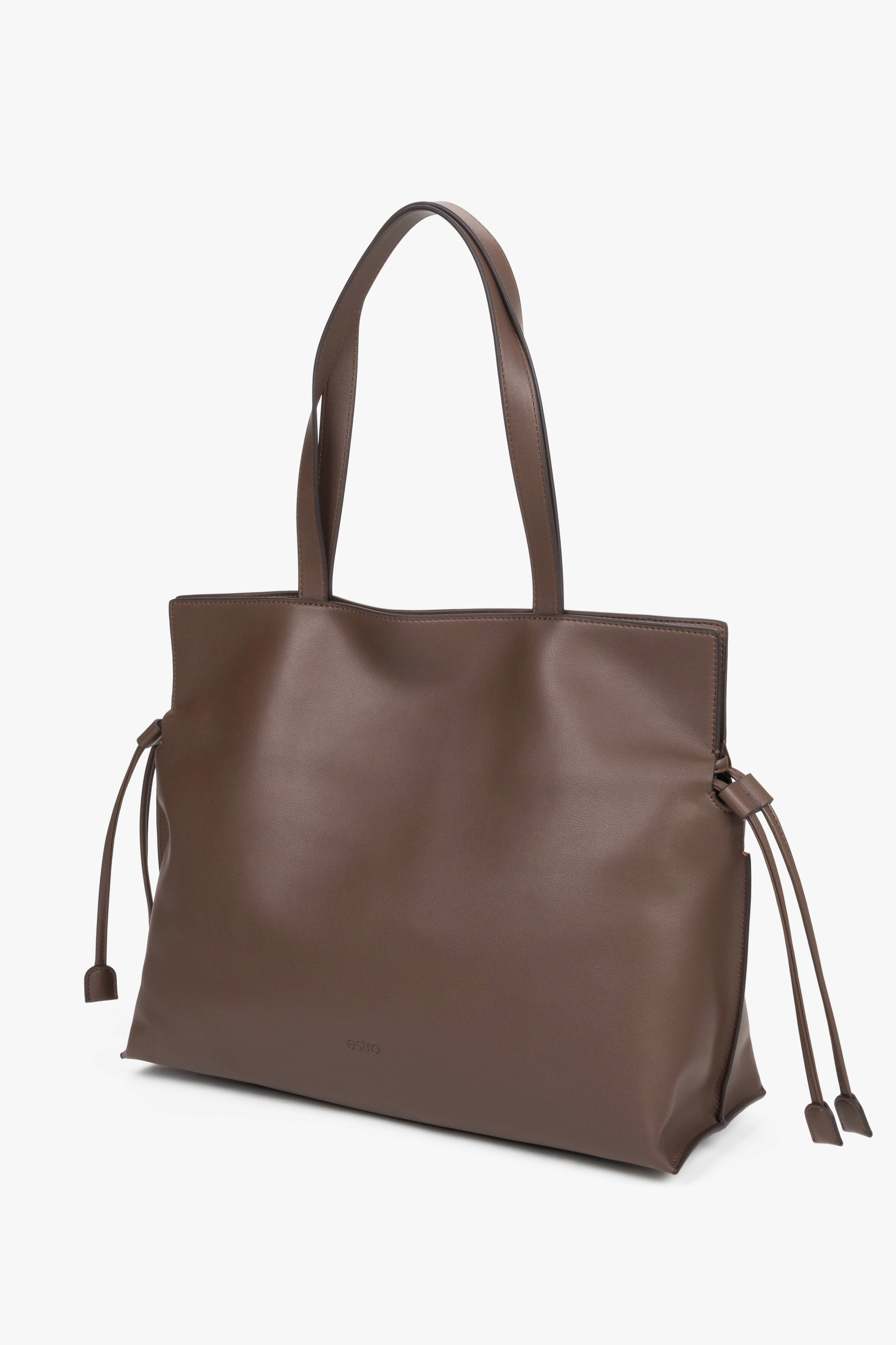 Leather shopper bag with a 14 cm width and loose side ties, showcasing the softness and refined texture of smooth genuine leather.