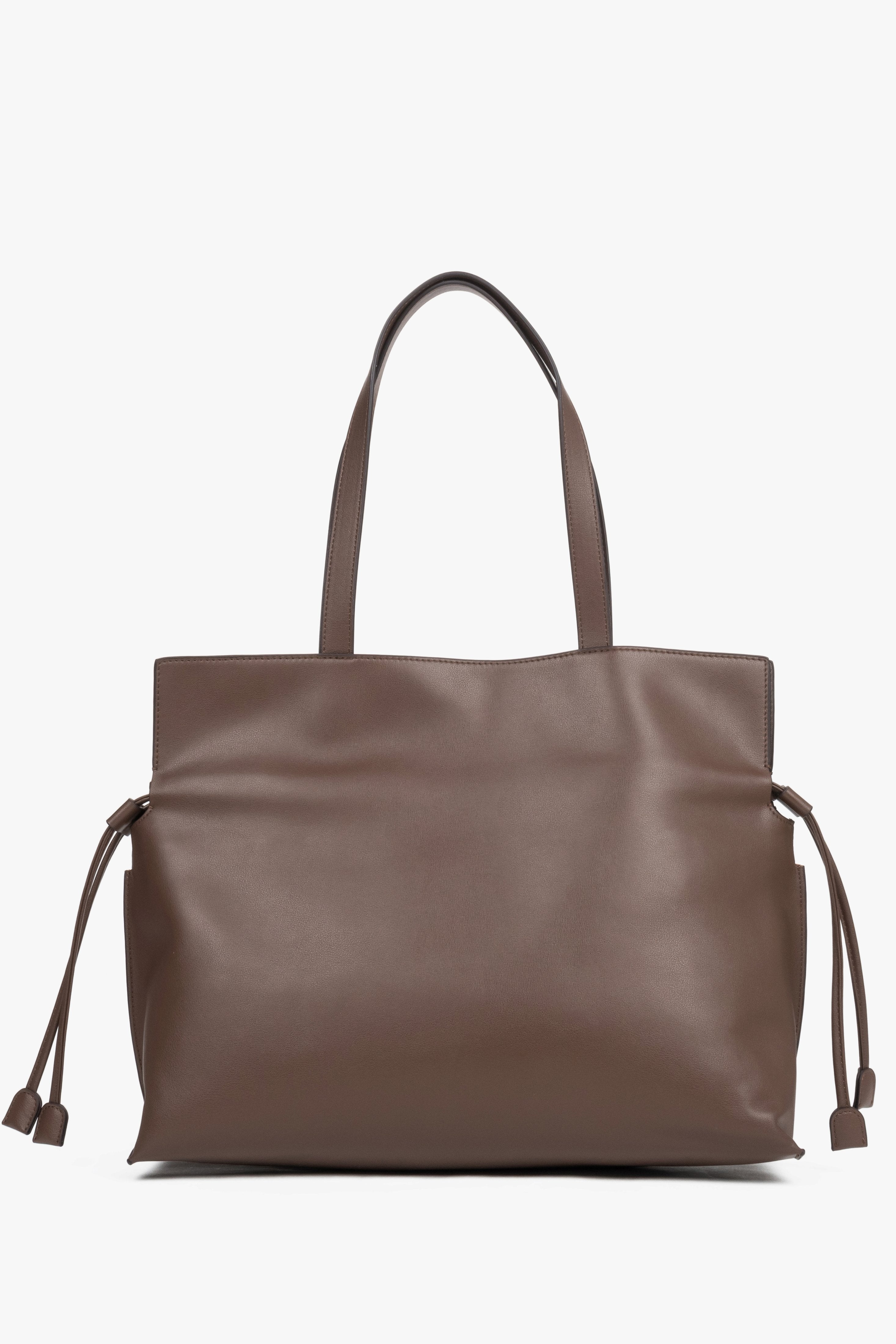 Close-up of a brown bag featuring adjustable side drawstrings that elegantly gather the sides and transform the silhouette of the bag.