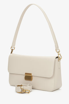 Women's light beige genuine leather crossbody bag with gold hardware.