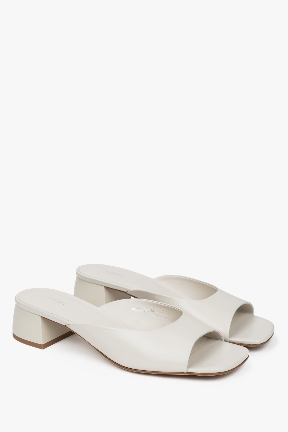 White women’s genuine leather mules with a low heel.