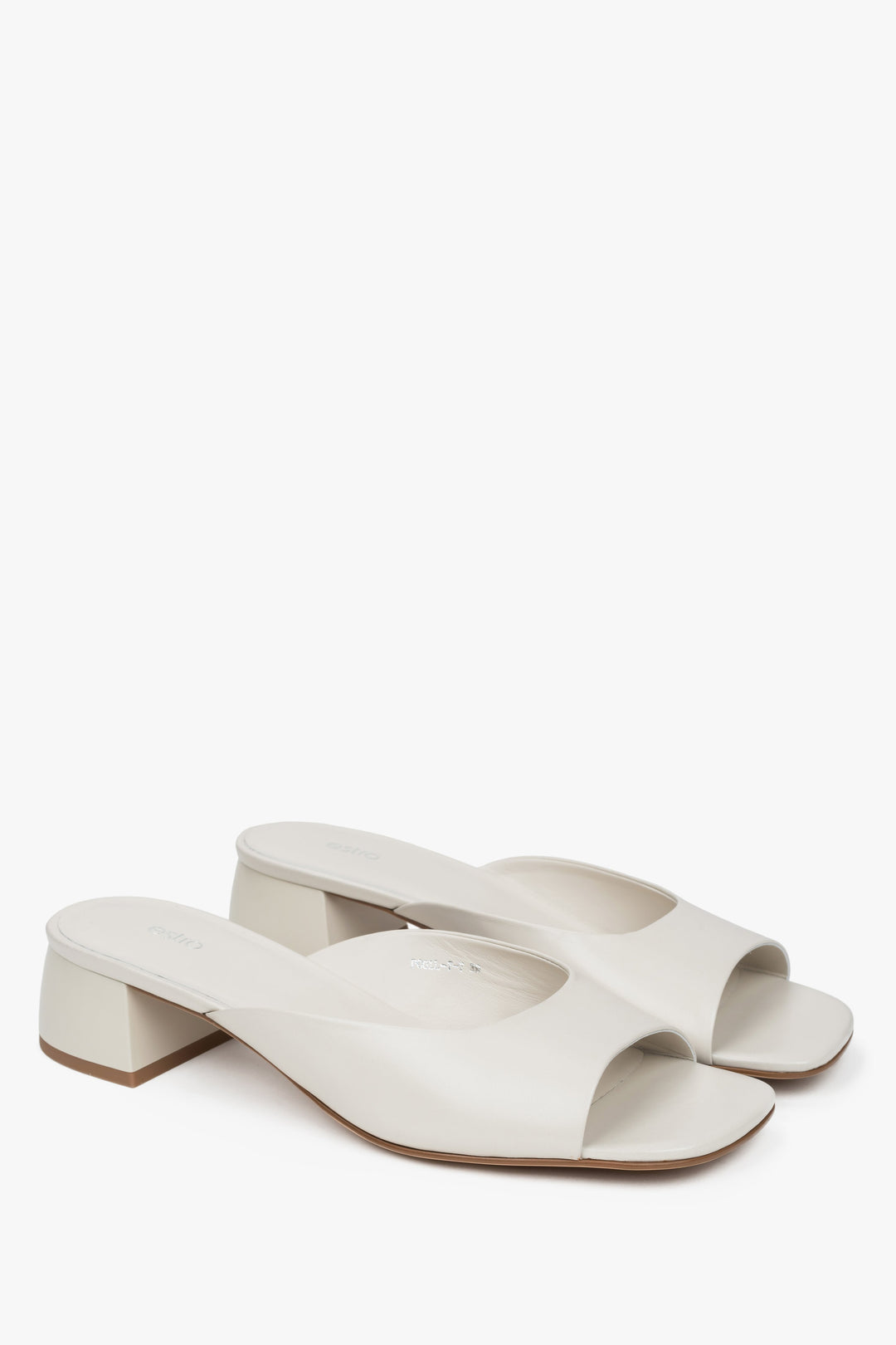 White women’s genuine leather mules with a low heel.