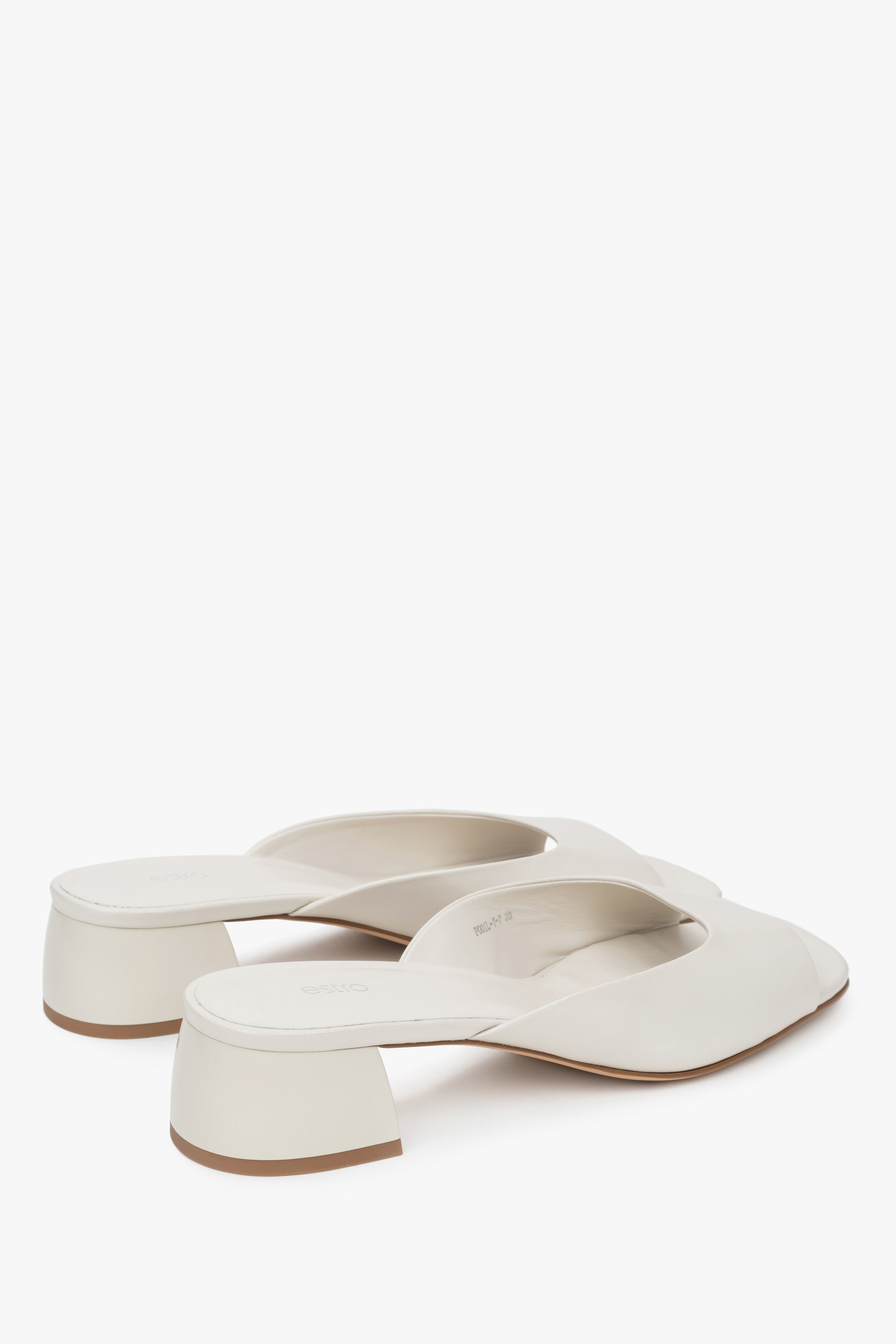 With a low heel, white women’s genuine leather mules by Estro.
