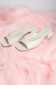 Women’s white genuine leather mules with a low heel by Estro.
