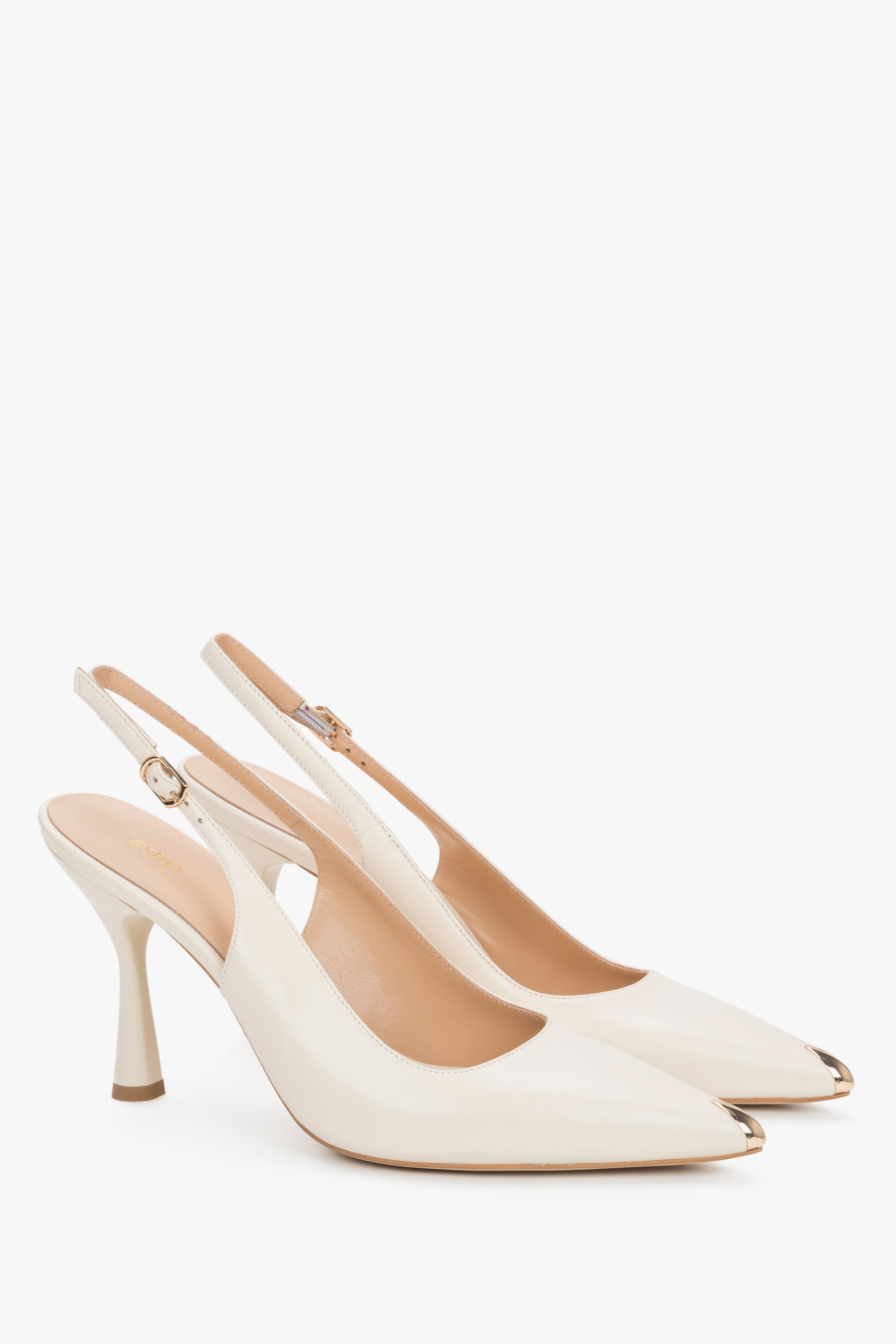 Light beige Estro slingback pumps on a statement flared (fluted) heel, featuring an open heel with a strap and a glossy gold pointed toe.