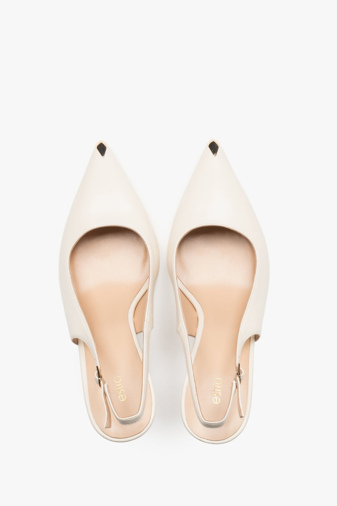 Top view of a pair of light blue pumps, showcasing a sharp pointed toe, a deeply cut vamp, and a light natural leather insole featuring the brand logo.