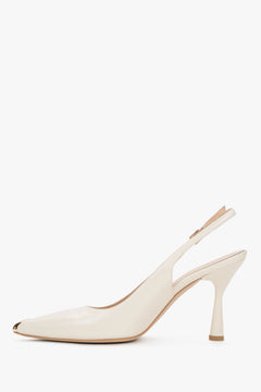 Elegant women’s shoes showcasing a stable flared heel profile and precise finishing of a metal buckle fastening.