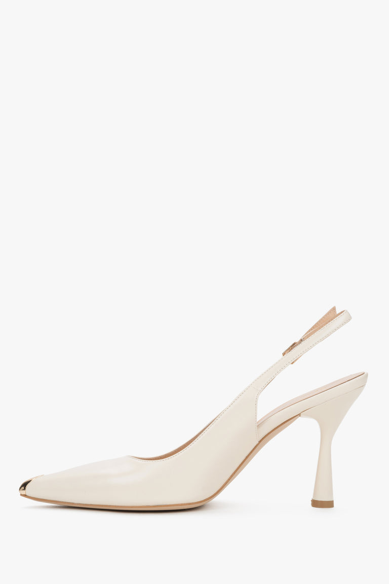 Elegant women’s shoes showcasing a stable flared heel profile and precise finishing of a metal buckle fastening.