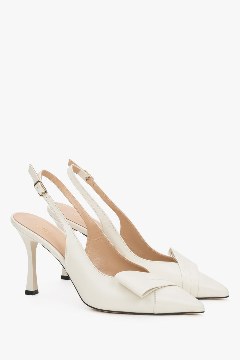 Light beige leather Estro slingback pumps on a high stiletto heel, featuring a deep vamp, a geometric toe detail, and a slim strap around the heel.