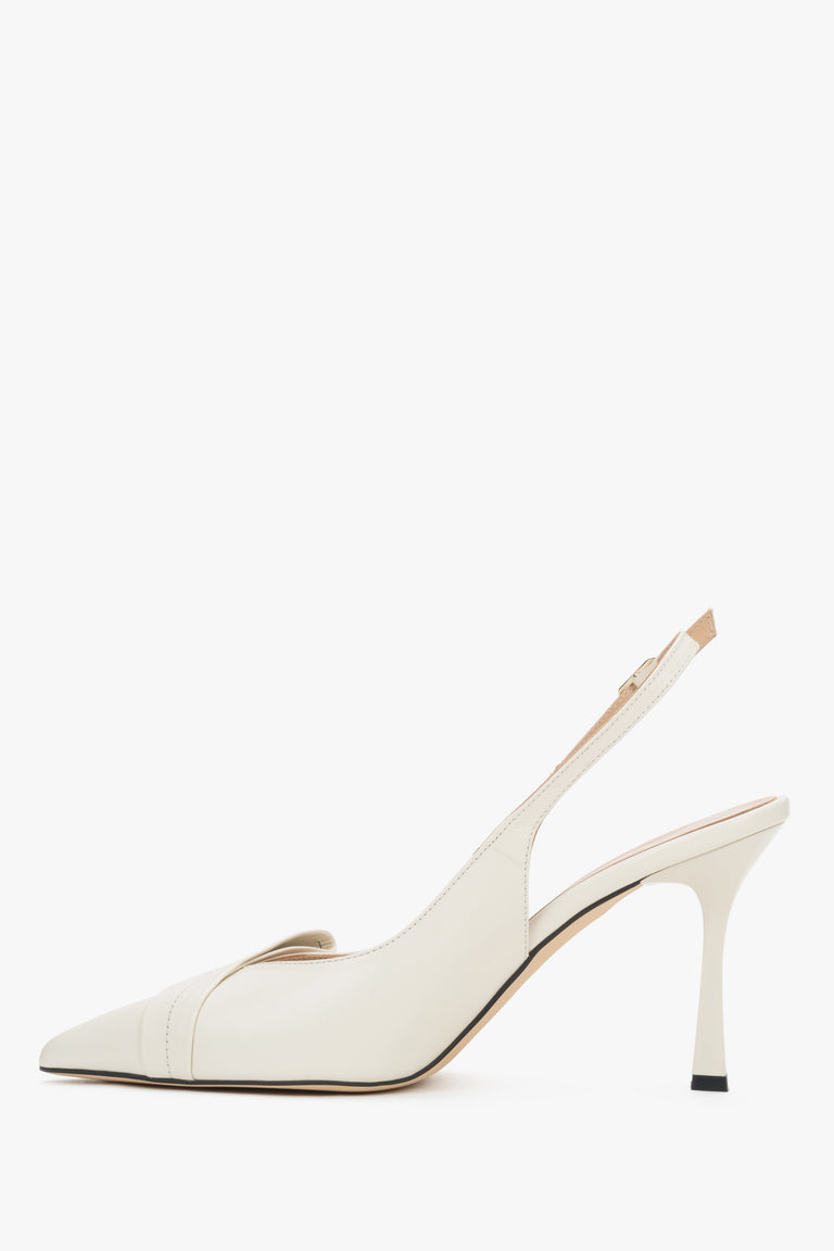 Elegant beige women’s shoes showcasing a perfectly contoured arch line and a subtle metal buckle fastening.