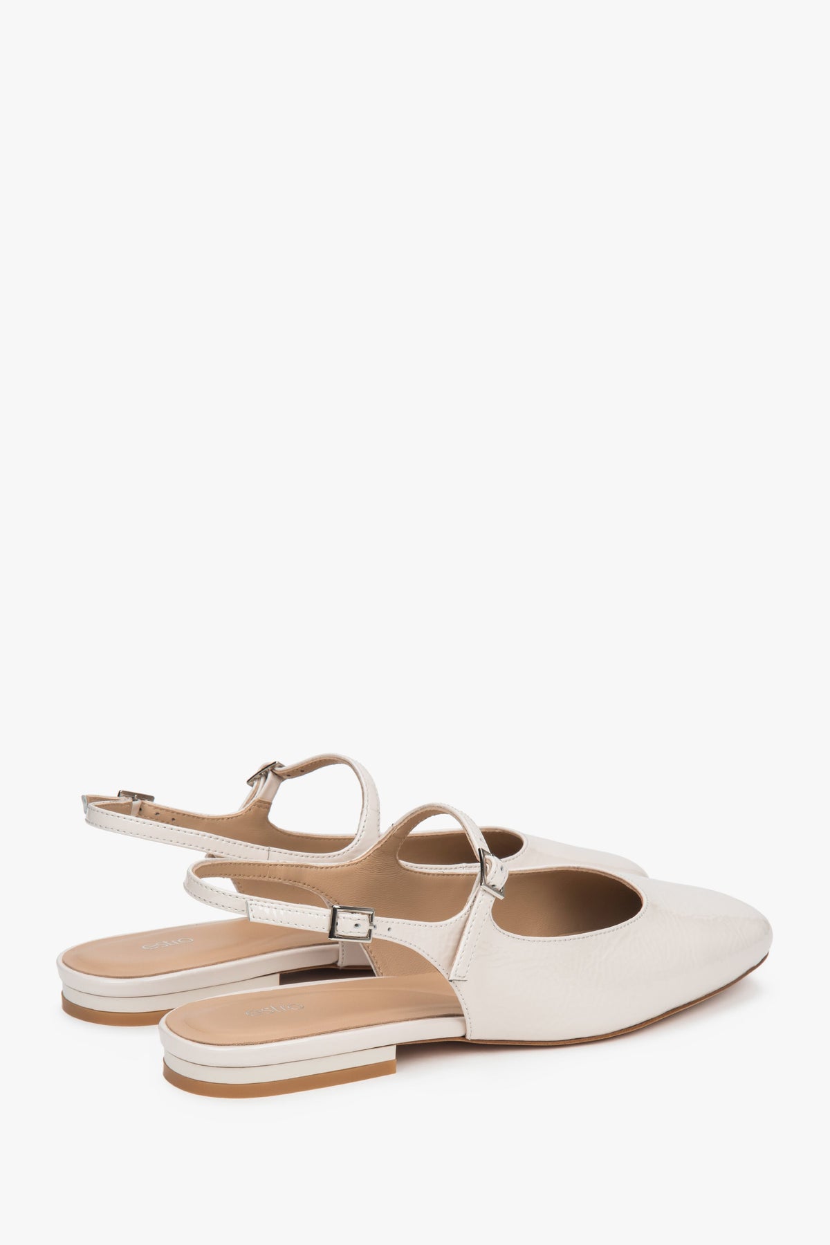 Women's light beige patent leather flats with slingback strap.