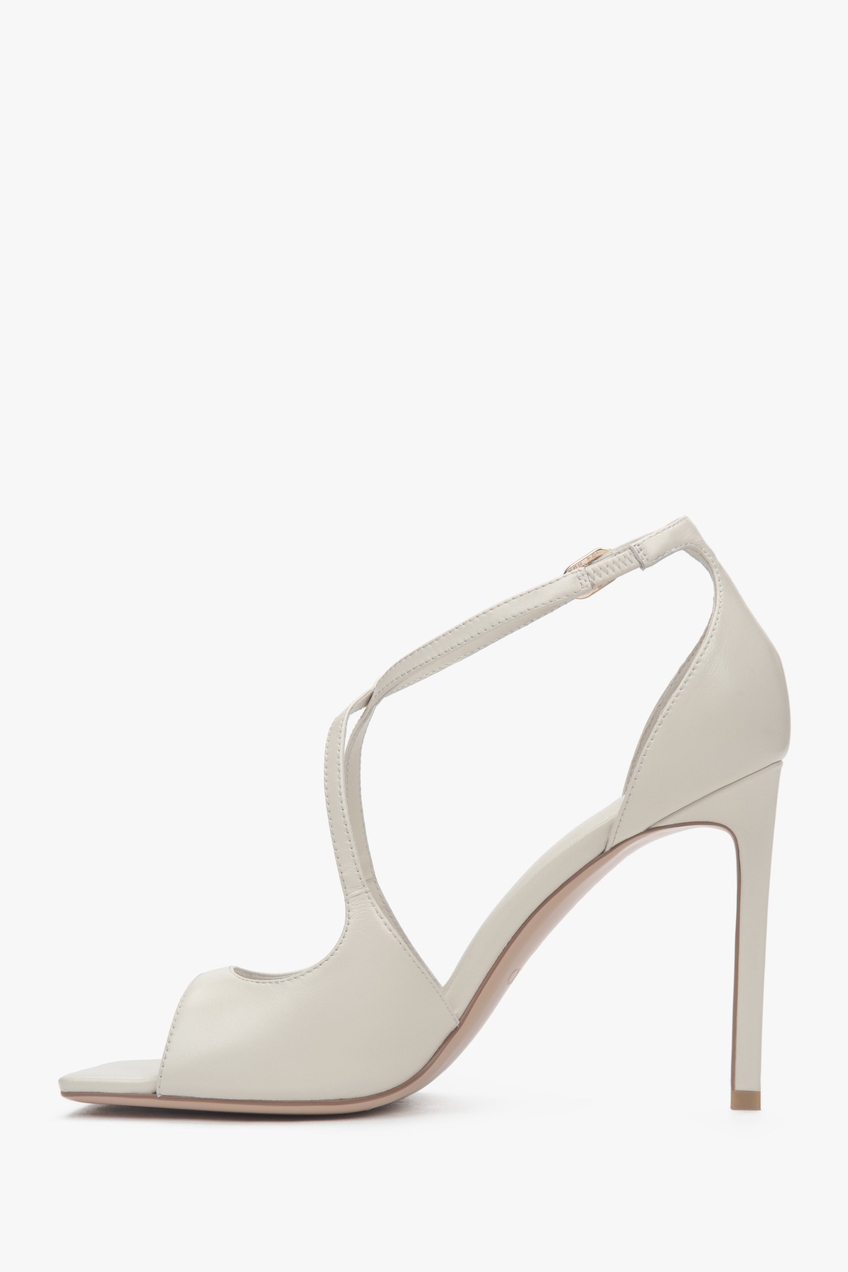 Women’s light beige stiletto sandals with decorative fastening by Estro.