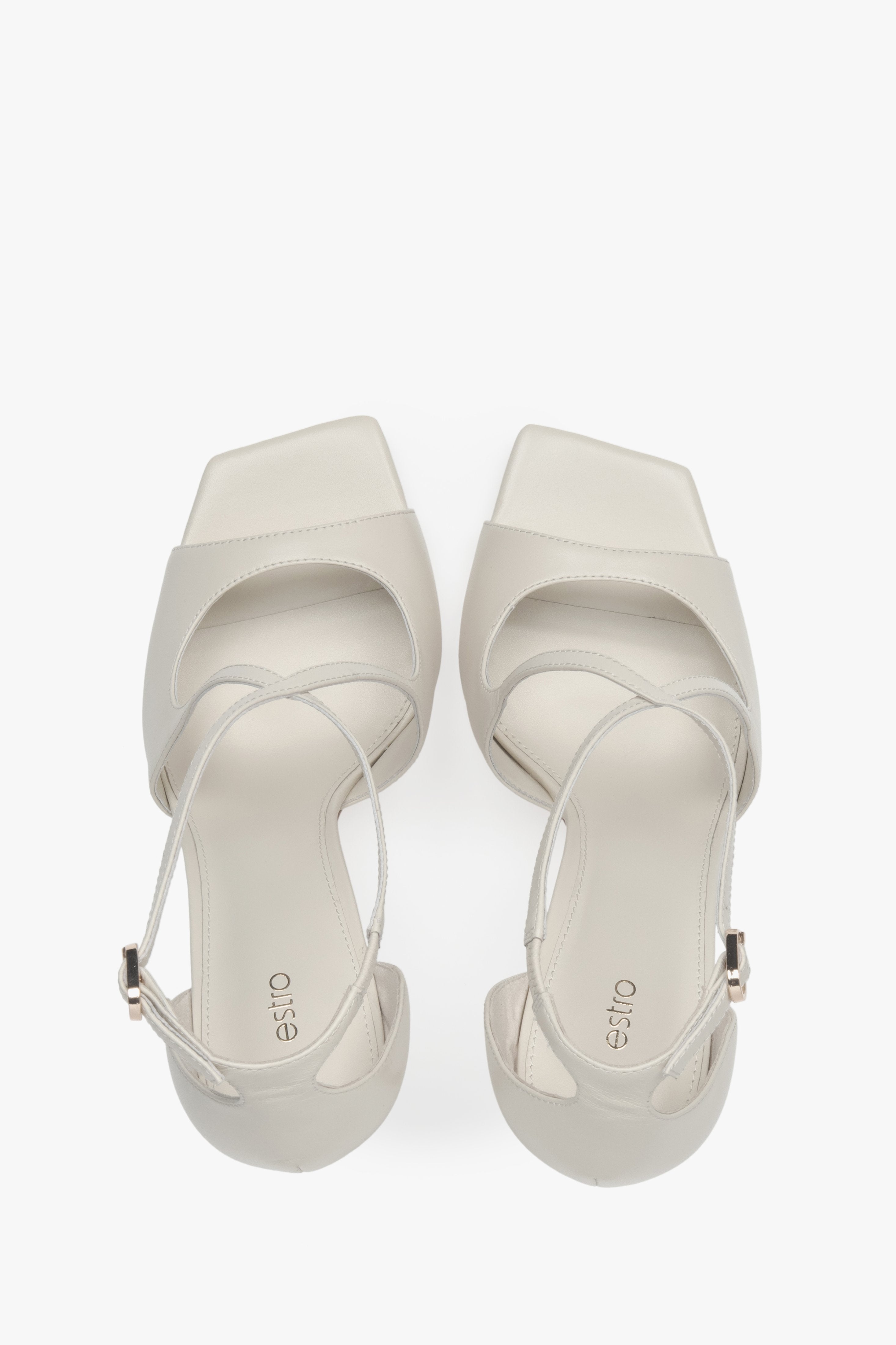 Women’s light beige stiletto sandals with decorative fastening by Estro – top view.