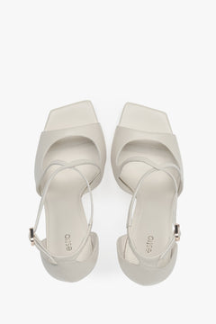Women’s light beige stiletto sandals with decorative fastening by Estro – top view.