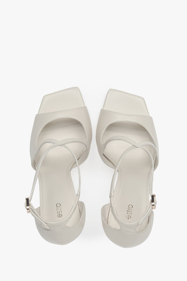 Women’s light beige stiletto sandals with decorative fastening by Estro – top view.
